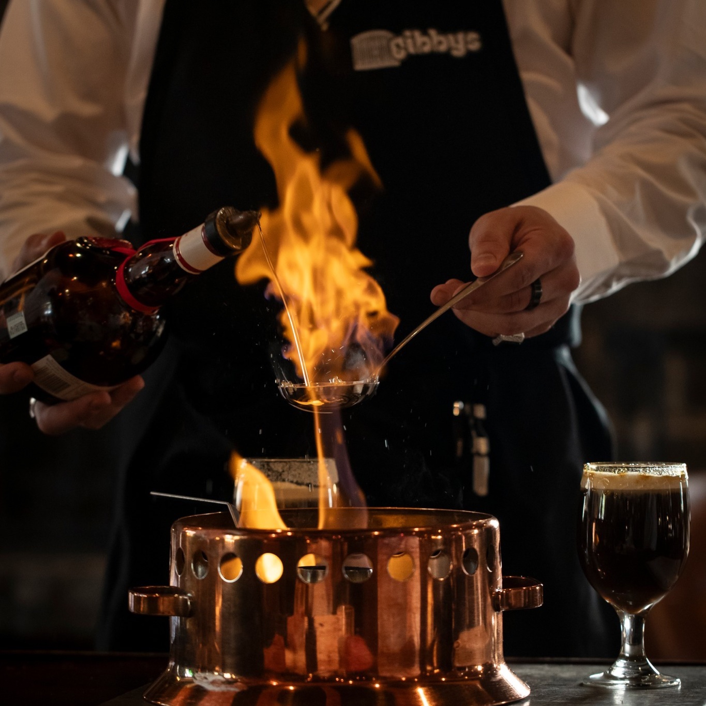 Gibby's steakhouse Old Montreal — stone walls, dark wood, dry-aged steak — the Montreal F1 weekend steakhouse cliché executed perfectly
